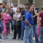 Venezuelans line up before casting their vote during presidential elections in Caracas