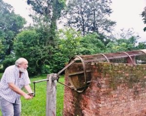 Don Eugenio Sitzmann demostrando el funcionamiento de la antigua máquina de sapecado de yerba mate